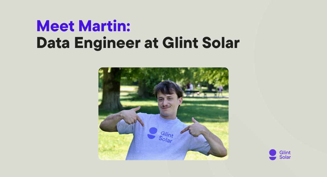 Image featuring 'Martin: Data Engineer at Glint Solar' with him pointing at his t-shirt logo, standing in a park.